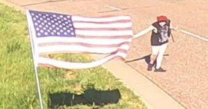 watch:-disgusting-moment-vandal-rips-7-flags,-flips-off-police
