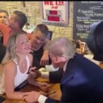 watch:-president-trump-makes-surprise-appearance-at-crowded-iowa-pub-after-campaign-speeches-–-signs-beaming-young-woman’s-top-and-dishes-out-pizzas-while-massive-crowd-cheers-|-the-gateway-pundit-|-by-cullen-linebarger