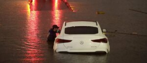wild-video-shows-man,-child-trapped-on-top-of-car-surrounded-by-roaring-floodwaters