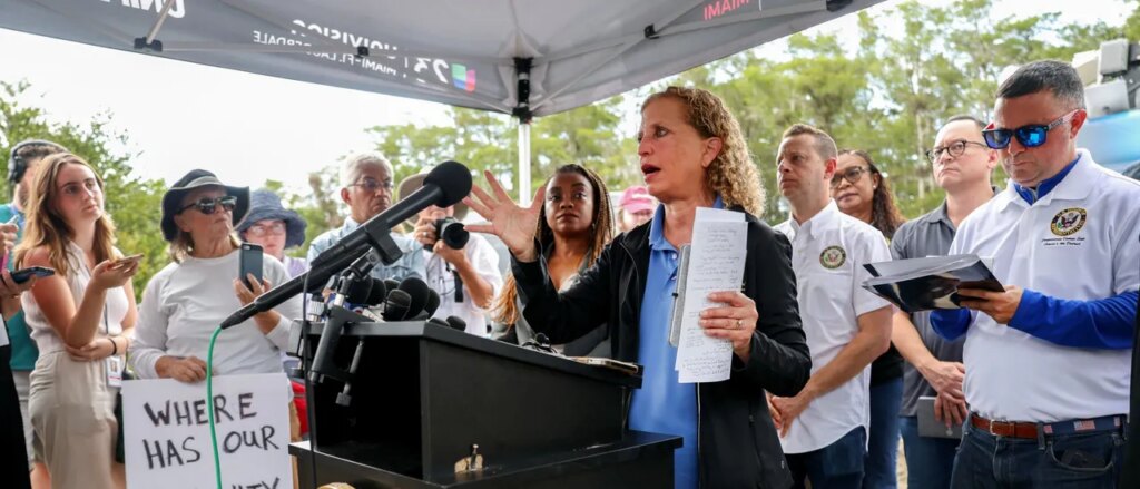 debbie-wasserman-schultz-announces-run-for-mainly-black-district-with-obama-poster-in-background