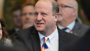 polis-protests-censure-on-colorado-democrats’-call-with-taped-mouth