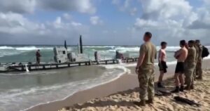 biden’s-gaza-pier-disaster:-us-vessels-beached-on-shore-after-heavy-waves