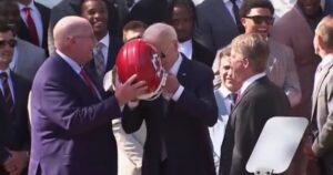 watch:-kansas-city-chiefs-laugh-at-biden-as-he-struggles-with-helmet