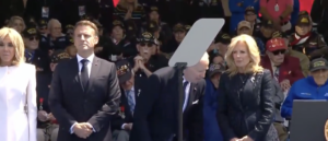 biden-hovers-between-sitting-and-standing-on-d-day-stage,-seemingly-confused