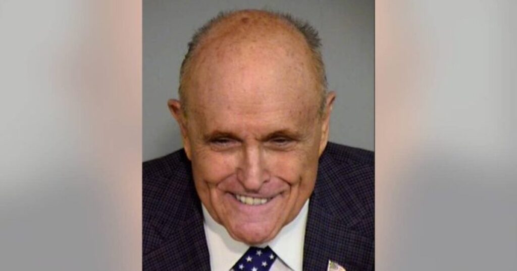 rudy-giuliani-smirks-in-mugshot-in-arizona-alternate-electors-lawfare-case